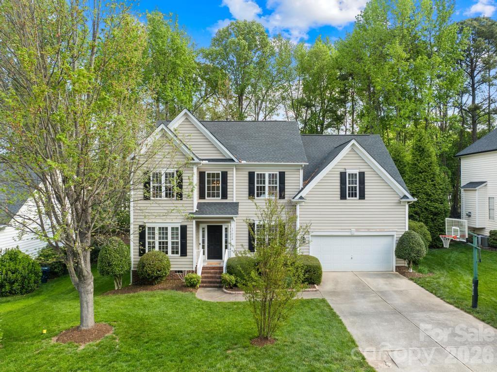 17028 Hampton Trace Road Huntersville, NC 28078 - Photo 2 of 41 a white house with a big yard plants and large trees