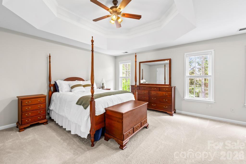 17028 Hampton Trace Road Huntersville, NC 28078 - Photo 21 of 41 a bedroom with a bed and a chandelier