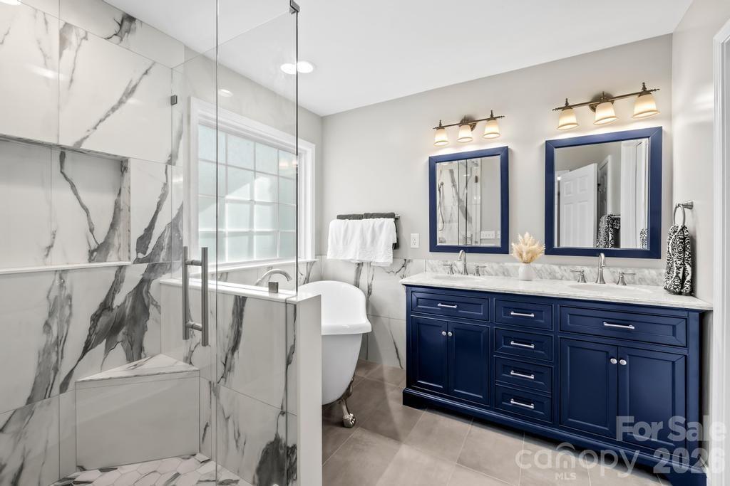 17028 Hampton Trace Road Huntersville, NC 28078 - Photo 23 of 41 a spacious bathroom with a granite countertop tub sink and mirror