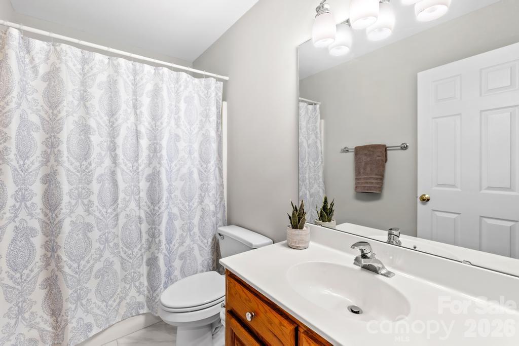 17028 Hampton Trace Road Huntersville, NC 28078 - Photo 28 of 41 a bathroom with a sink a toilet and a large mirror