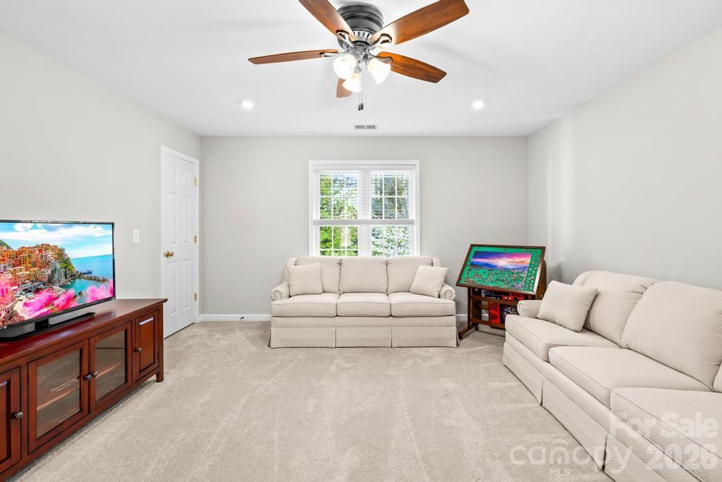 17028 Hampton Trace Road Huntersville, NC 28078 - Photo 29 of 41 a living room with furniture and a flat screen tv