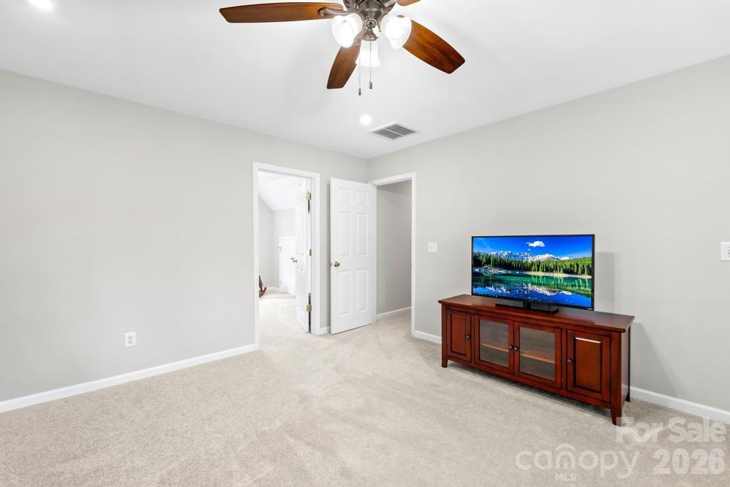 17028 Hampton Trace Road Huntersville, NC 28078 - Photo 30 of 41 a living room with furniture and a flat screen tv