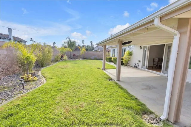 a view of a porch with furniture and garden
