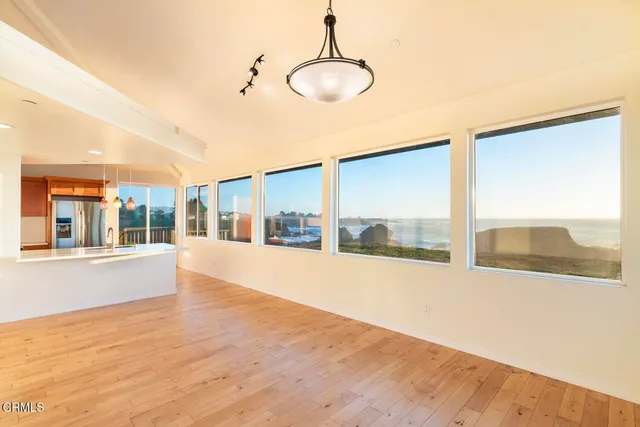 a very nice looking room with a large window and kitchen view