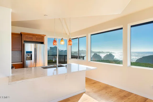 a view of a living room and kitchen