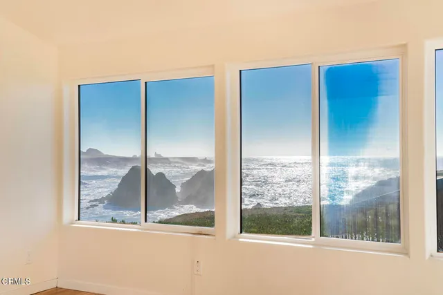 a view of a room with wooden floor and windows