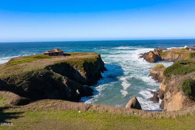 a view of a roof deck with wooden floor and fence with a floor to ceiling window