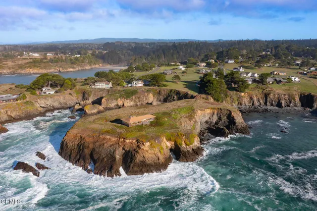 an aerial view of residential building and mountain view in back
