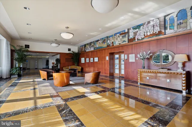 a living room with furniture a rug and a book shelf