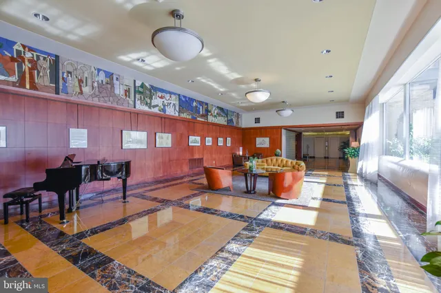 a living room with furniture a rug and a large window