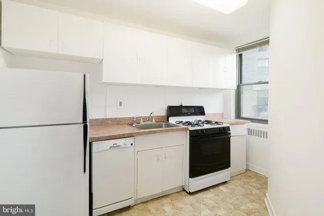 a kitchen with a stove and a refrigerator