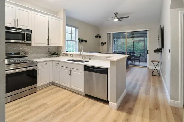 a kitchen with a sink stove and wooden cabinets