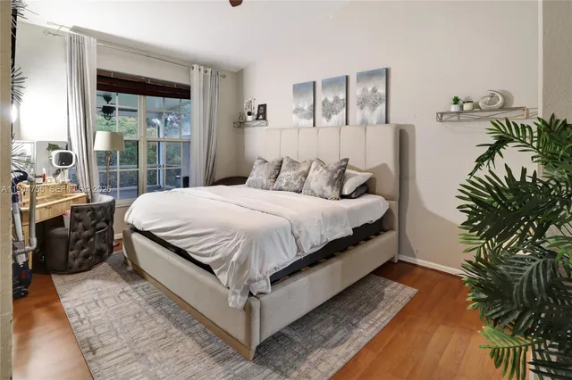 a bed sitting in a bedroom next to a window