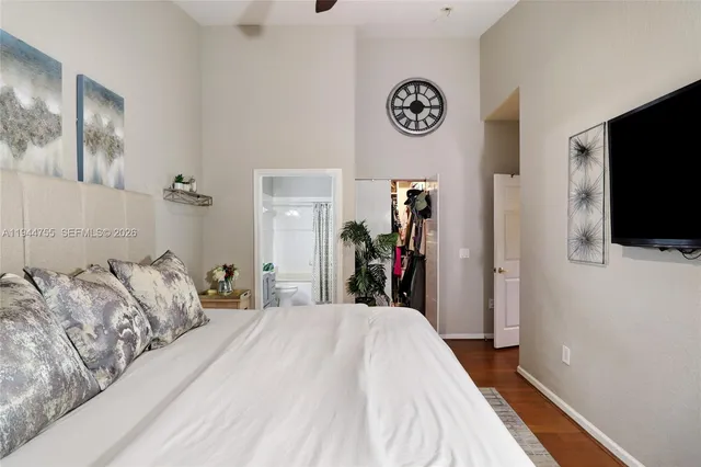 a bed room with a bed and a flat tv screen