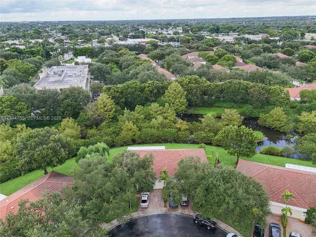 an aerial view of a houses with a yard