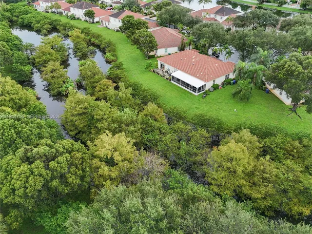 an aerial view of a house with garden space and street view