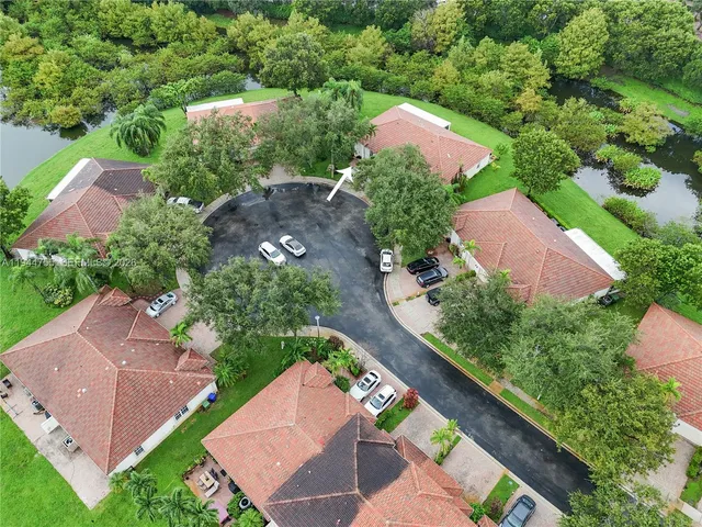 an aerial view of a house with a garden and trees