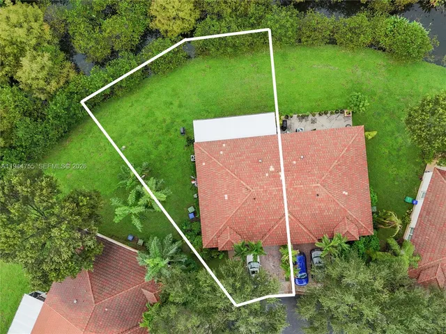 a backyard of a house with plants and a park