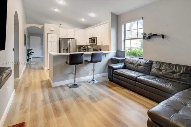 a living room with furniture and a wooden floor