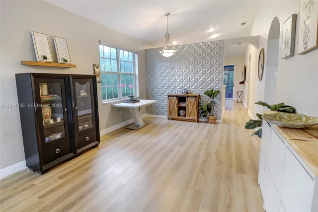 a open kitchen with a sink a stove and a wooden floors