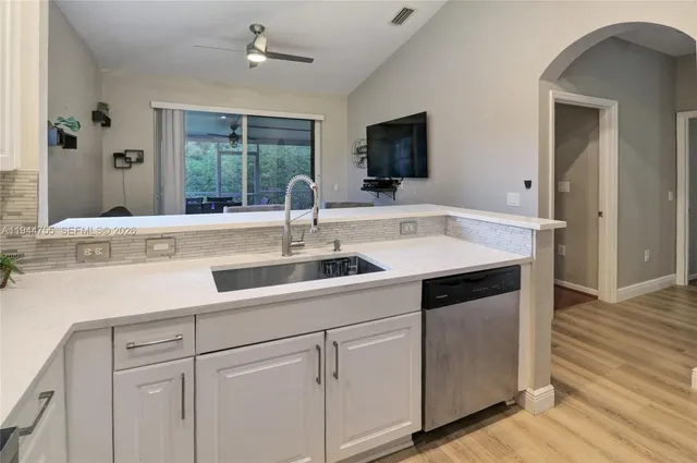 a kitchen with a sink and cabinets