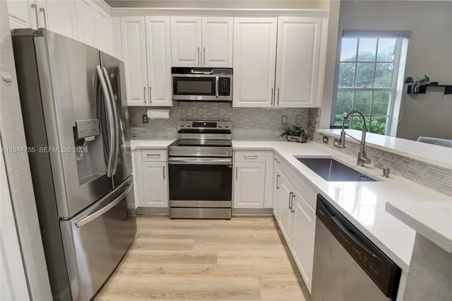 a kitchen with a sink stove and refrigerator
