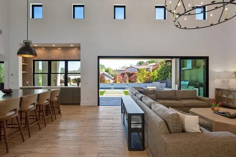 a kitchen with stainless steel appliances granite countertop a stove a sink and a wooden floors