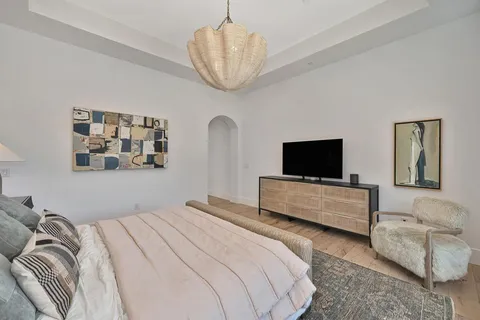 a living room with furniture a chandelier and a table