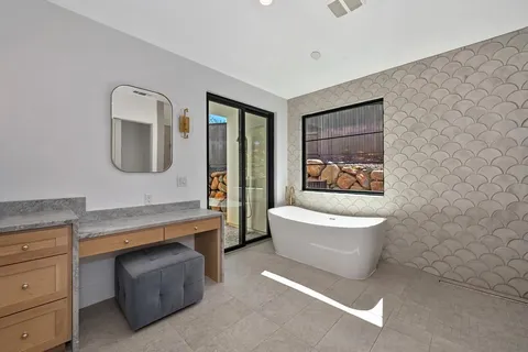 a bathroom with a granite countertop toilet sink and mirror