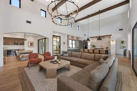a living room with lots of furniture and a chandelier