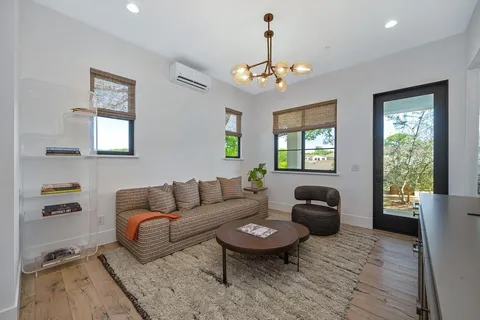 a view of swimming pool with outdoor seating and a garden