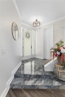 a view of a room with wooden floor and hallway