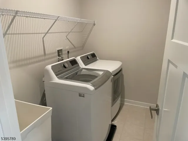 a view of an empty room with wooden floor and closet