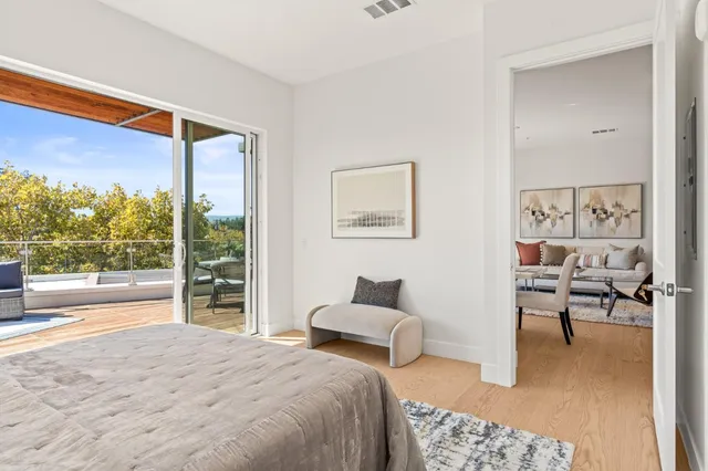 a bedroom with furniture and a large window