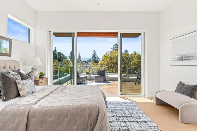 a bedroom with a large window and a bed