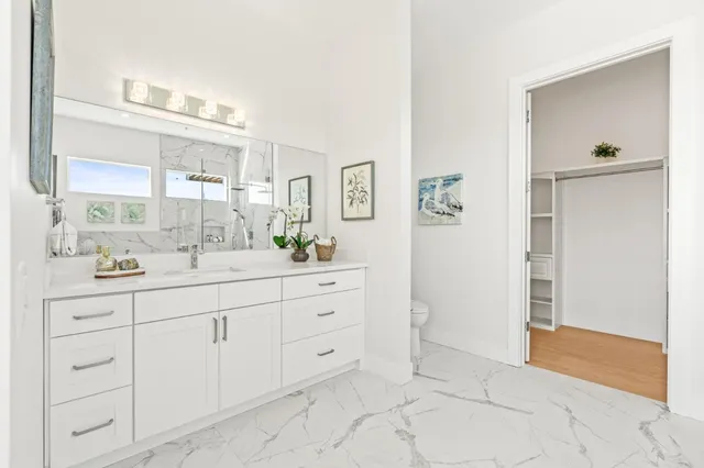 a bathroom with a granite countertop sink a vanity and a mirror