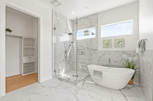 a bathroom with a bathtub and shower