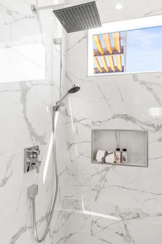 a bathroom with a bathtub and a shower