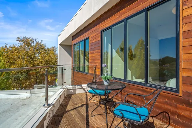 a backyard of a house with table and chairs