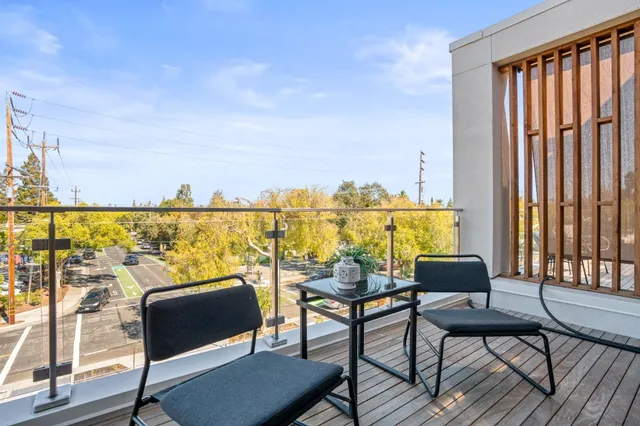 a balcony with table and chairs