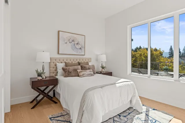 a bedroom with a bed and a painting on the wall