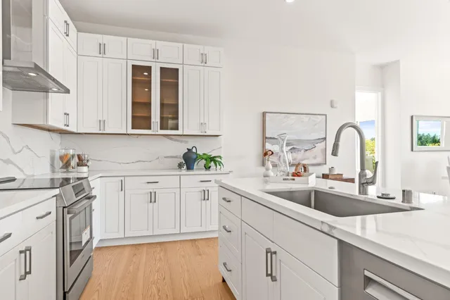 a kitchen with a sink stove and cabinets