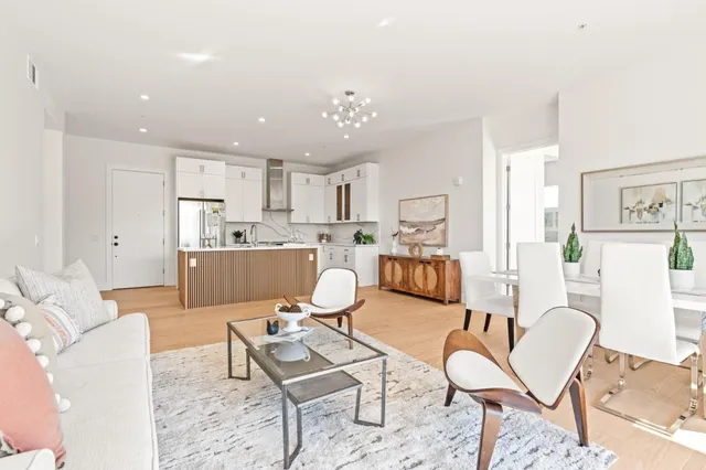 a living room with furniture and kitchen view