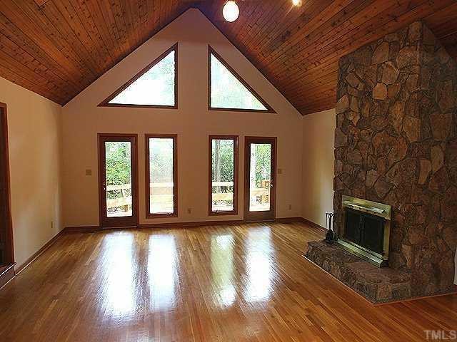 11330 Saddleview Court Raleigh, NC 27613 - Photo 3 of 10 a view of an empty room with wooden floor and a window