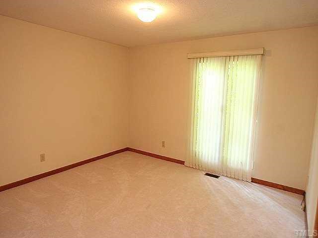 11330 Saddleview Court Raleigh, NC 27613 - Photo 8 of 10 an empty room with a window