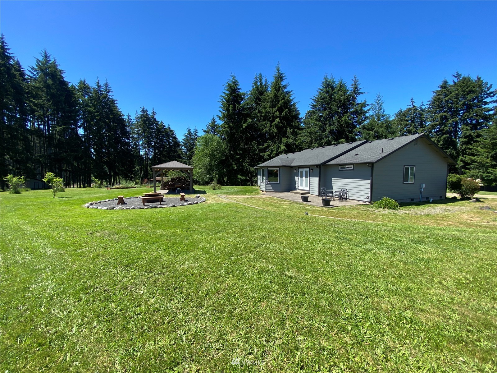 105 Cristler Road Chehalis, WA 98532 - Photo 11 of 37 a front view of house with a garden and trees