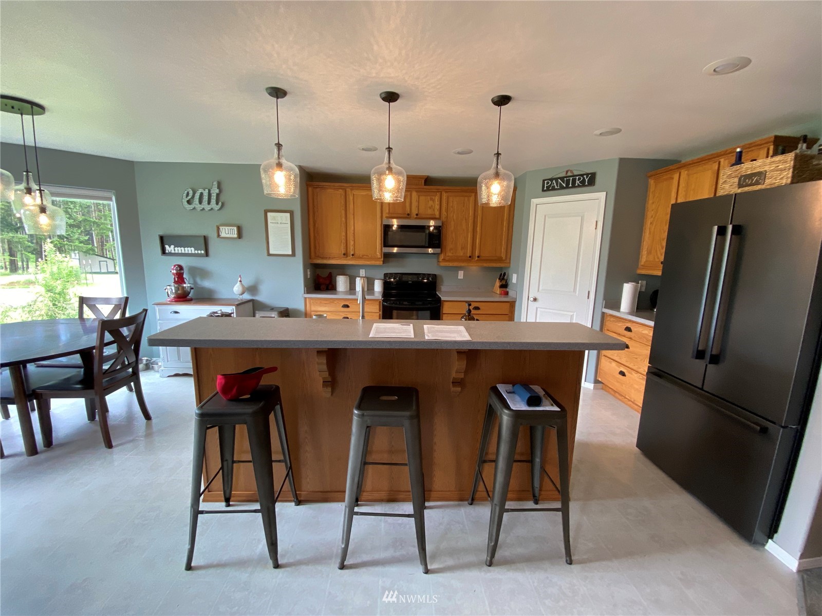 105 Cristler Road Chehalis, WA 98532 - Photo 18 of 37 a kitchen with stainless steel appliances kitchen island granite countertop dining table chairs and a refrigerator