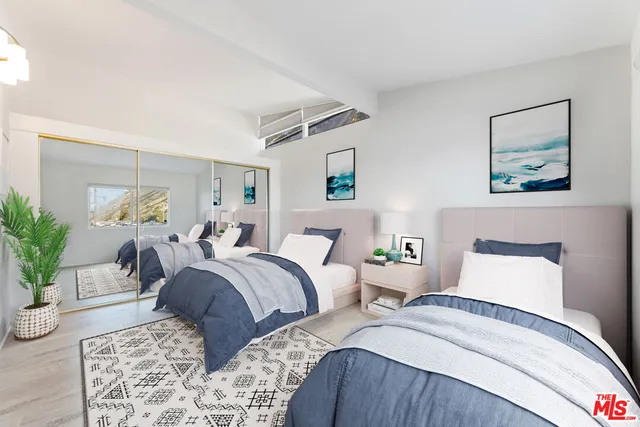 a bed room with a bed and a potted plant