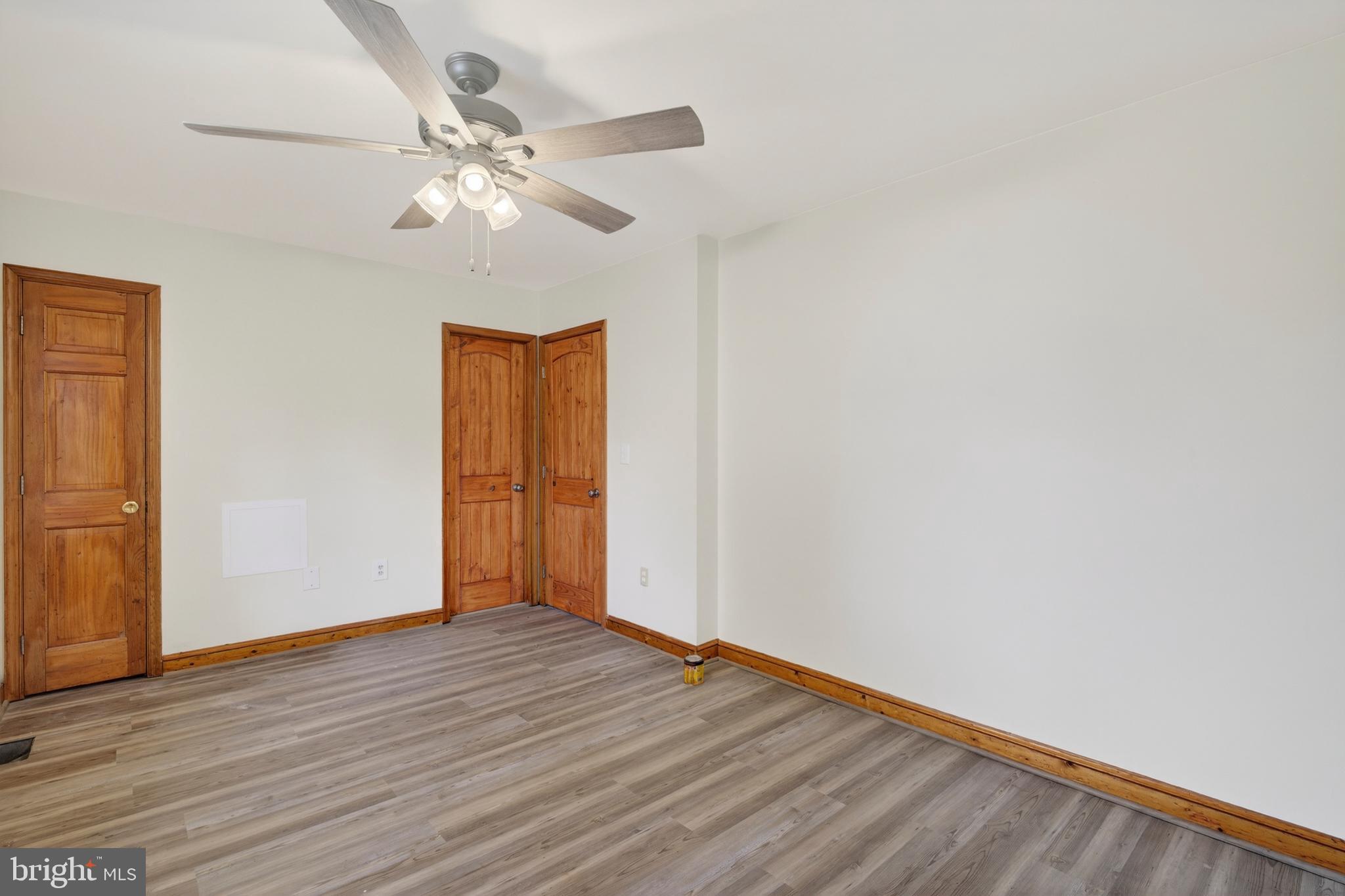 4037 1st Street Chesapeake Beach, MD 20732 - Photo 15 of 26 a view of an empty room with wooden floor