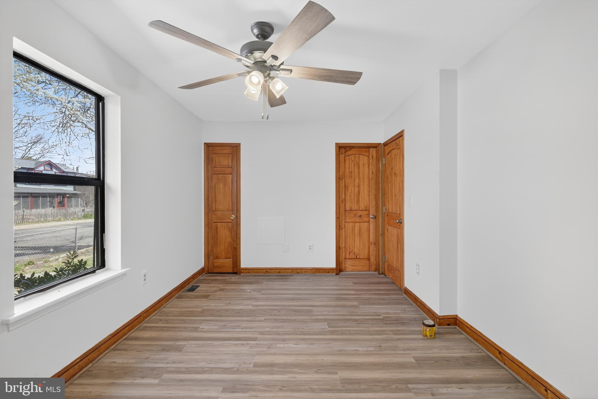 4037 1st Street Chesapeake Beach, MD 20732 - Photo 16 of 26 a view of empty room with wooden floor and fan
